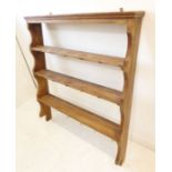 A set of early 20th century stained pine wall-hanging shelves (95cm wide x 117cm high)