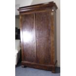 A 19th century flame mahogany French armoire; the outset cornice above two figured doors enclosing