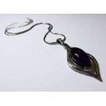 A teardrop-shaped silver pendant centrally-set with an amethyst dropper, suspended upon a silver