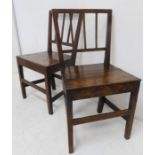 A pair of late 18th century vernacular oak side chairs; planked seats and square legs united by