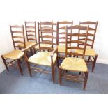 A set of seven (6 +1) well made and patinated Lancashire ladderback-style chairs; rush seats and