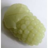A Chinese pale celadon jade carving of grapes and vine leaves, together with a similar sized