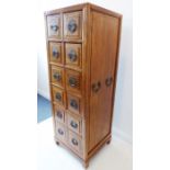 A good Chinese elm chest of tall and slim proportions; the figured cleated top above twelve half-