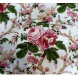 A pair of curtains decorated with pink floral sprays and green leaves, edged in burgundy, thick