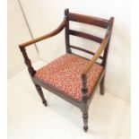 An early 19th century Regency period opened armed mahogany carver chair; tablet-shaped slightly