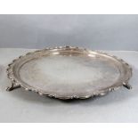 A Georgian-style (later) hallmarked silver circular salver; scalloped edge and on three shaped feet,