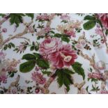 A pair of curtains decorated with pink floral sprays and green leaves, edged in burgundy, thick