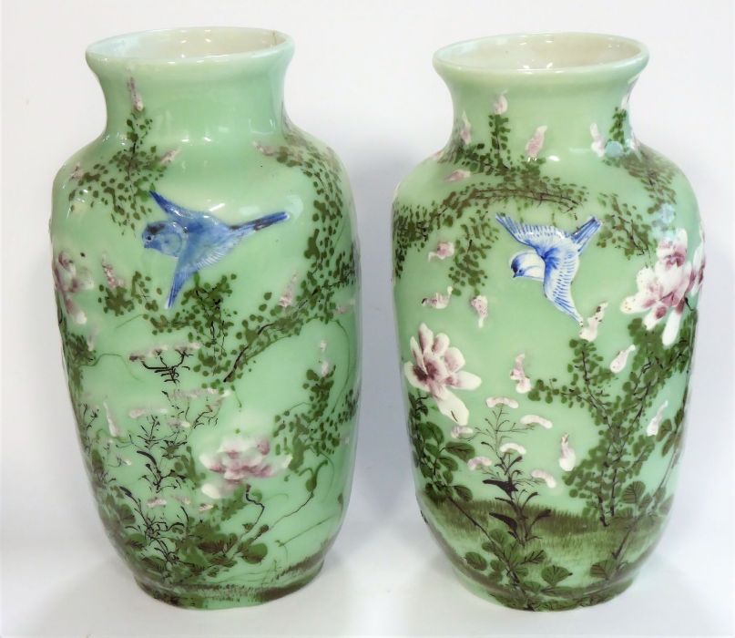 A pair of 19th century Japanese porcelain vases; hand-decorated with swallows and in the air above