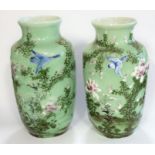 A pair of 19th century Japanese porcelain vases; hand-decorated with swallows and in the air above