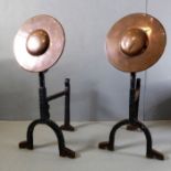 A pair of early 20th century Arts and Crafts copper and iron andirons; each with angular shield-