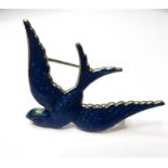 A blue enamelled brooch modelled as a swallow in flight, the reverse marked 'ANN KOPLIK DESIGNS' (