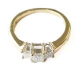 A 14-carat white-gold ring, set with three princess-cut diamonds, ring size