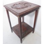 A late 19th century oak occasional table – the square gadrooned top carved with armorial crest