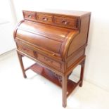 A reproduction Chinese hardwood cylinder bureau in 19th century style – cleated top above three