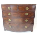 An early 19th century mahogany chest; the reeded edge top above two half-width and three full-