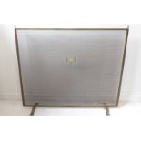 A large brass-framed and wire-mesh fireguard (97cm wide x 81cm high)