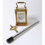 A miniature brass carriage clock with key