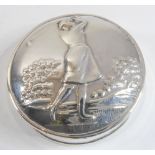 A silver pill box; the top embossed with a female golfer – import marks for Sheffield assay office.