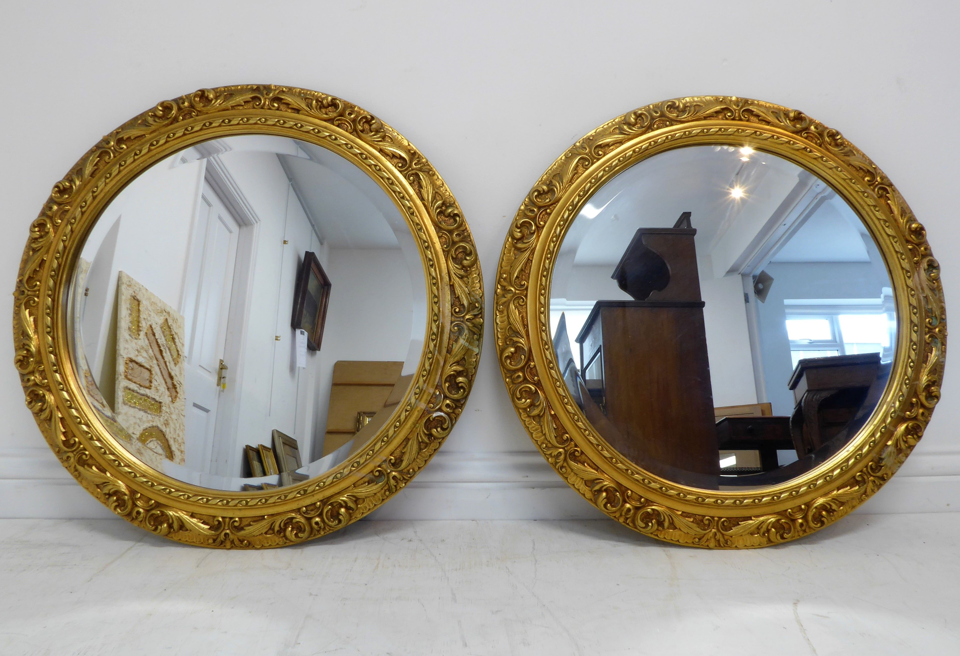 A pair of antique-style (reproduction) circular gilt-framed wall-hanging looking glasses having