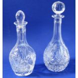 Two fine quality hand-cut baluster-shaped decanters; one with replaced stopper