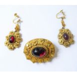 A mid 19th century brooch and pair of ear pendants en-suite, each of oval design, centrally set with