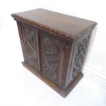 A good late 19th century mahogany table cabinet – the two panelled doors carved in relief with