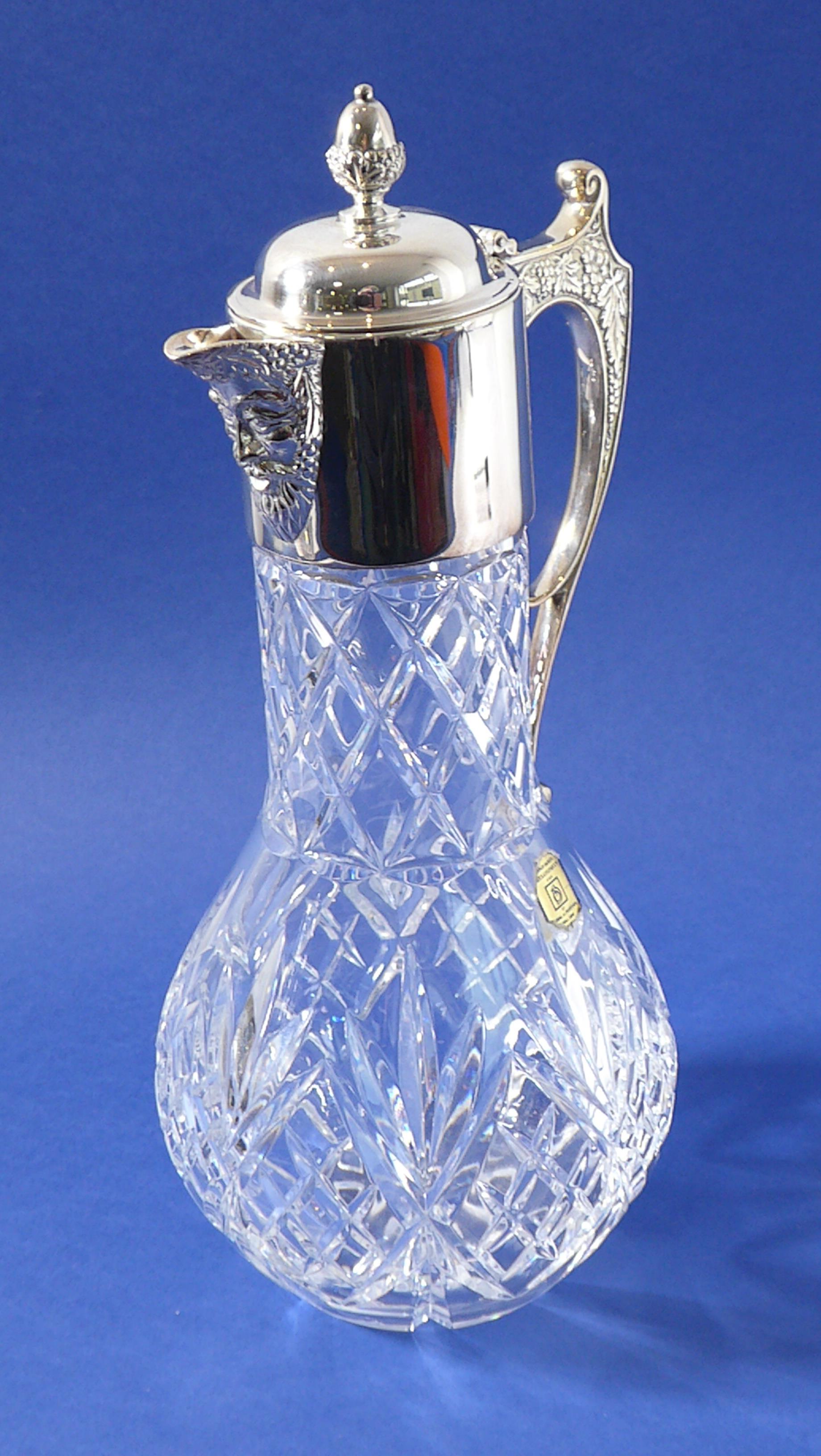 A Portuguese lead crystal claret jug; baluster-shaped, silver-plated mounts with the spout