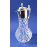 A Portuguese lead crystal claret jug; baluster-shaped, silver-plated mounts with the spout