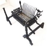 A large and heavy andirons and fire grate set, the corners unusually modelled as open-mouthed