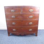 An early 19th century bow-fronted mahogany chest; the caddy-style cross-banded top above two half-