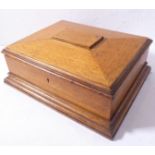 A good late 19th /early 20th century sarcophagus-shaped oak sewing box and its contents