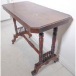 An Edwardian mahogany occasional table of rectangular form with canted corners and four turned