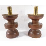 An interesting pair of turned hardwood and brass-mounted candlesticks; the base with punched