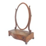 A late 18th century serpentine-fronted mahogany and chequer-strung toilet mirror with oval plate