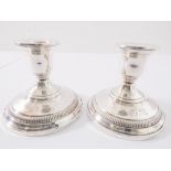 A pair of sterling silver dwarf candlesticks.