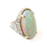 A fine 18-carat gold ring set with a large opal and mixed cut brilliant diamonds, size N Condition