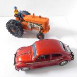 A mid-20th century tinplate and plastic electric toy tractor and a Japanese battery powered