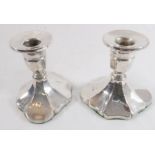 A pair of silver dwarf candlesticks with lobed bases –hallmarked Birmingham 1922 and maker's mark