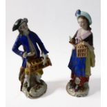 A pair of late 19th century Continental hand-decorated porcelain figures; hunter and companion