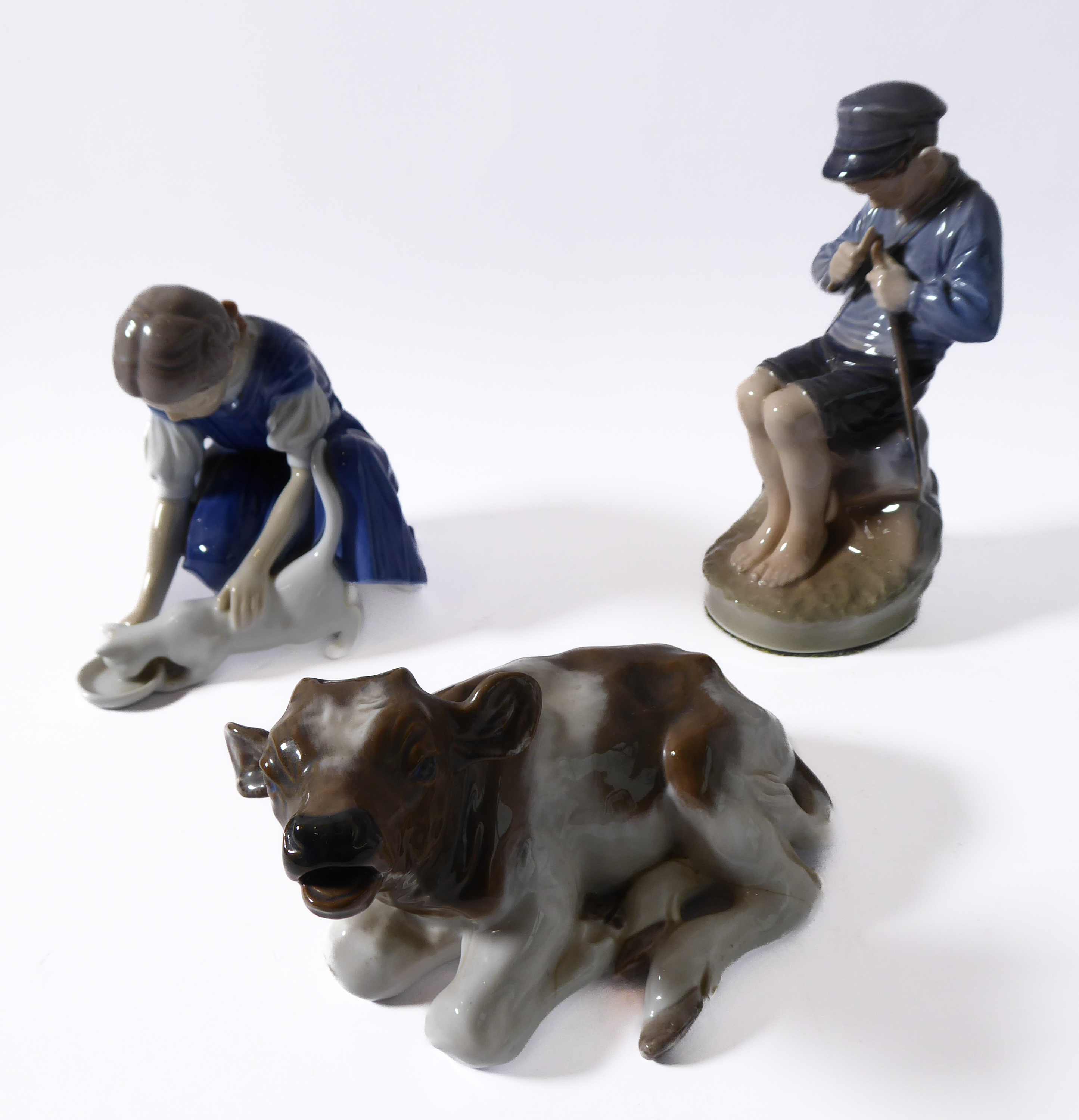 Royal Copenhagen porcelain figure group (mid 20th century, Danish factory), a seated young boy