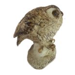 A painted stoneware figure of an oversized little owl - the underside marked HT 83 (tip of