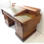 A good 19th century mahogany desk; the three-quarter galleried top with sloping inset writing fall