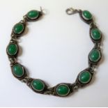 A silver bracelet set with ten green hardstones polished en-cabochon (in presentation box)