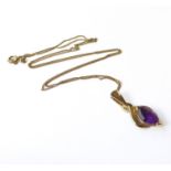 A 9-carat gold and amethyst pendant with a 9-carat gold chain