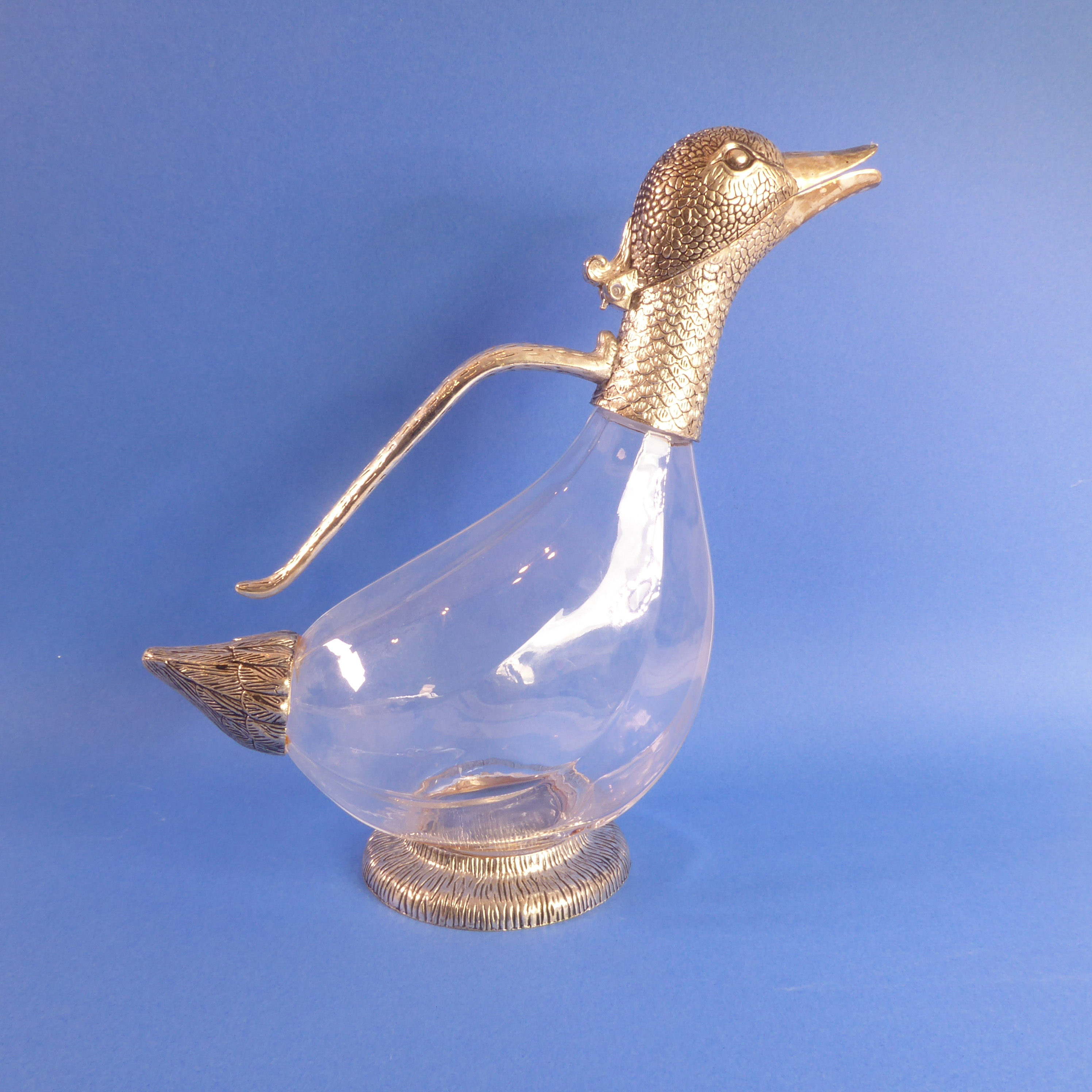 A modern wine decanter in the form of a duck; silver-plate mountings and fluted glass body (27cm