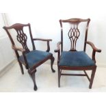 Two similar and large mahogany open armchairs (carvers) in 18th century style, one standing on
