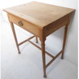An early 20th century natural wood finish side table; single full-width drawer with cast oval handle
