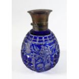 An early 20th century hand-cut blue-glass, silver-mounted, scent bottle of ovoid form; the hinged