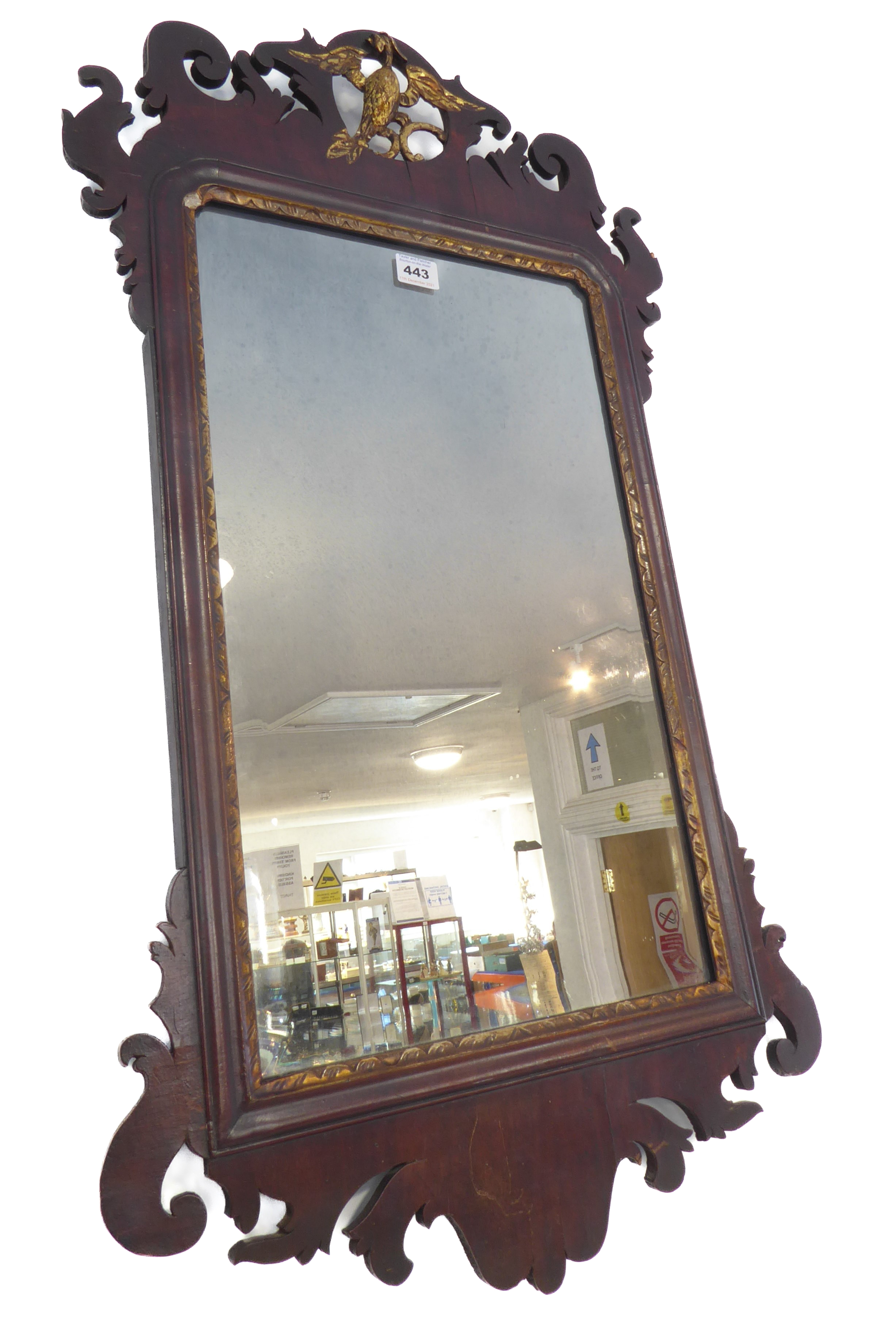 A George III 18th century mahogany and parcel-gilt wall-hanging looking glass; the pierced