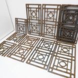 Eleven decorative pierced cast-iron grates; each centred with a circle with geometric patterns